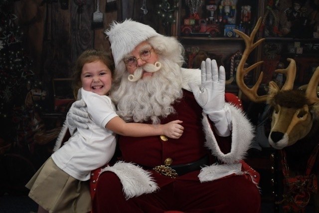 student hugging Santa