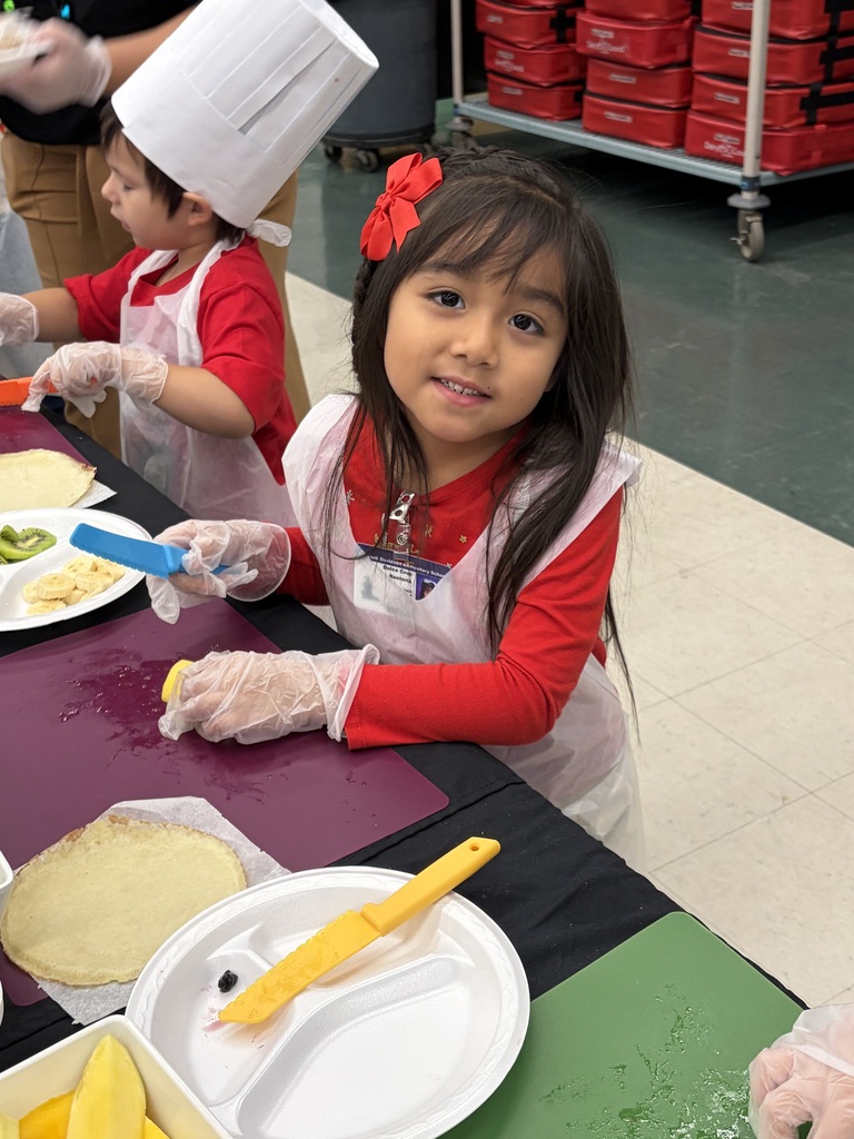 student in an apron making lunch