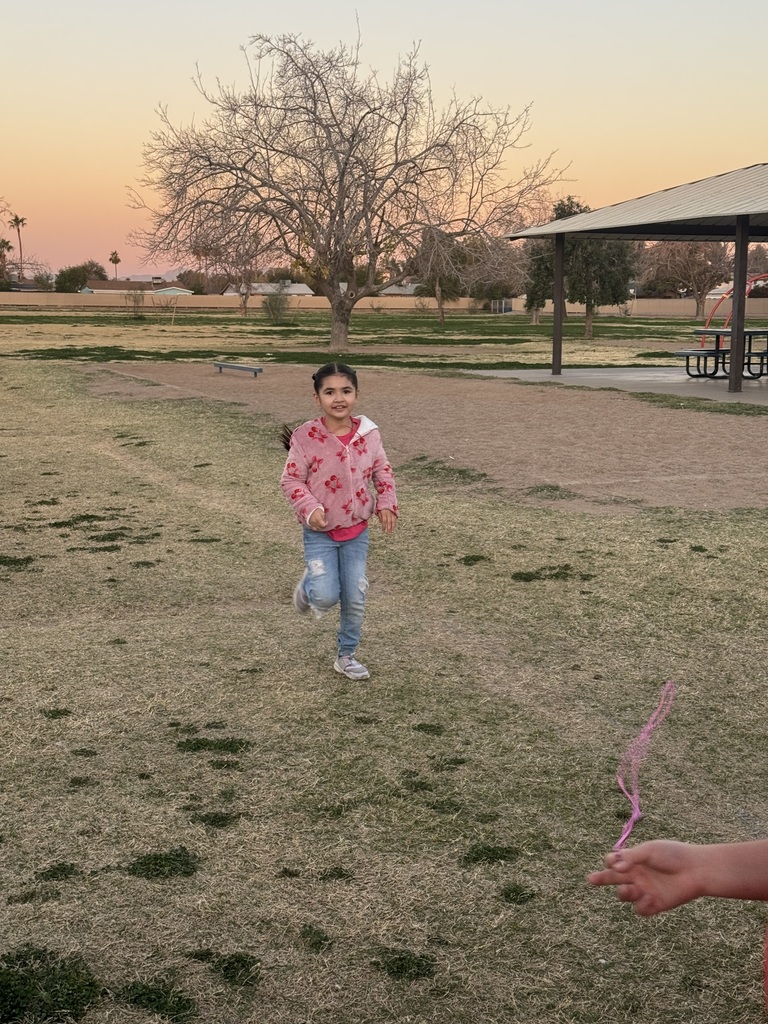 Girl in pink sweater with red hearts running to get her pink necklace