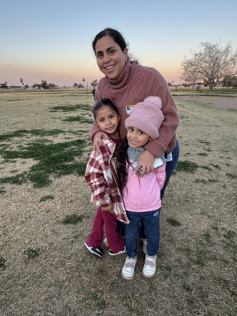 Family all dressed in pink smiling