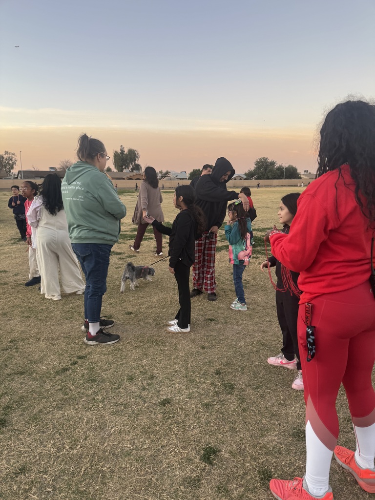 Two teachers passing out necklaces to runners