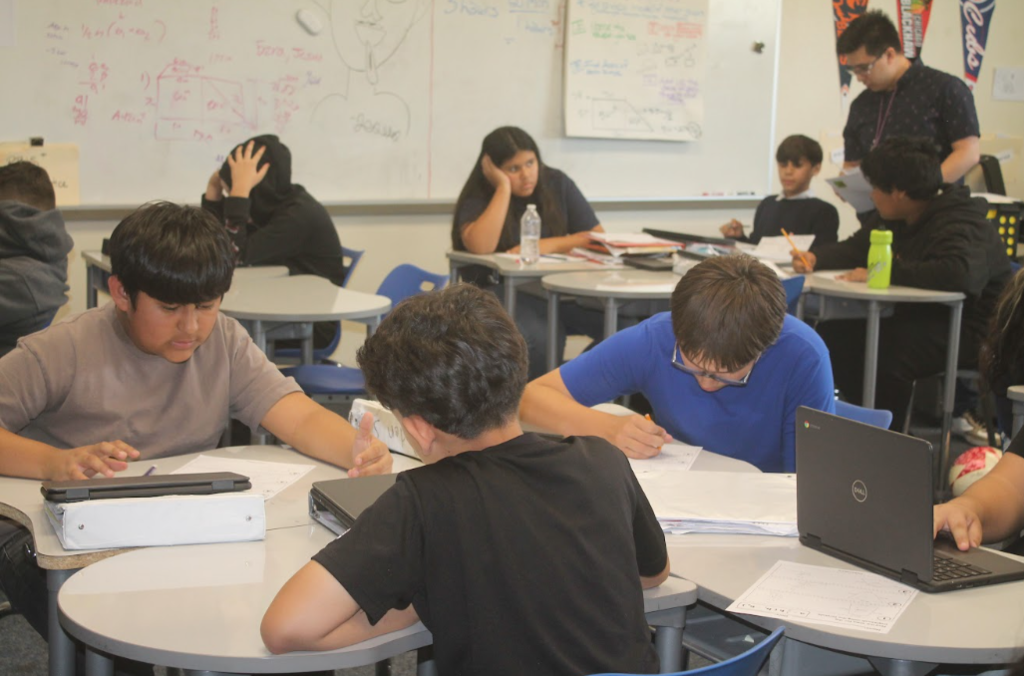 7th grade students in ELA, Science, Math, and Social Studies classrooms actively participating in hands-on and multimedia lessons while teachers guide instruction.