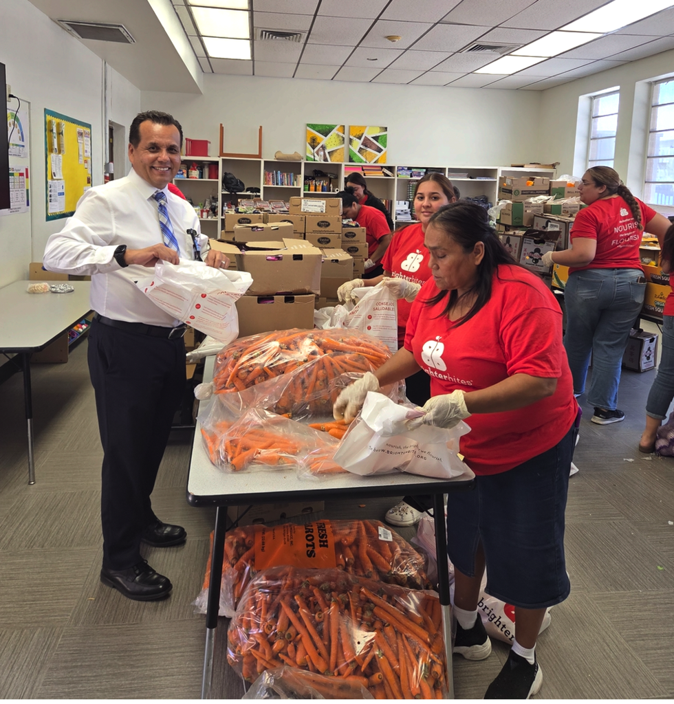 Dr. Barrantes SantaMaria, Acting Superintendent helping with Brighter Bites