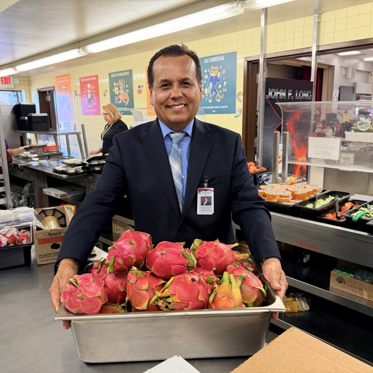 superintendent holding dragon fruit