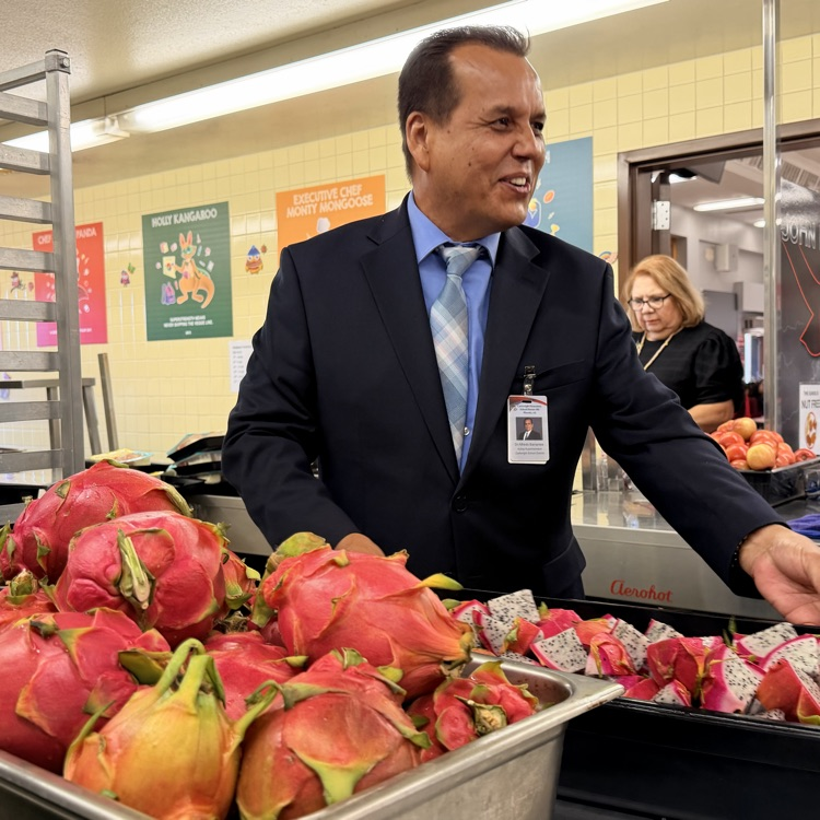 superintendent holding dragon fruit