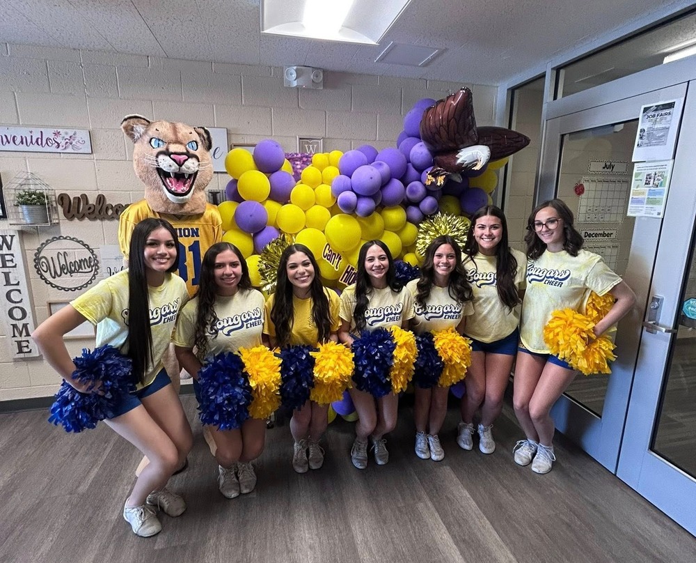 CGUHS cougar spiritline cheerleaders with cougar mascot in school front office