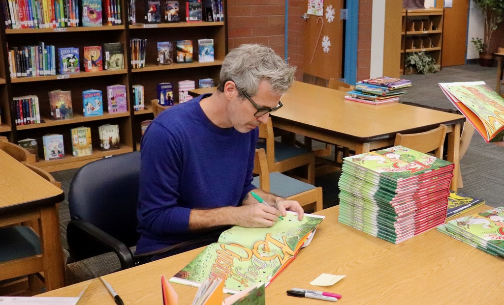 Adam rex signing his books