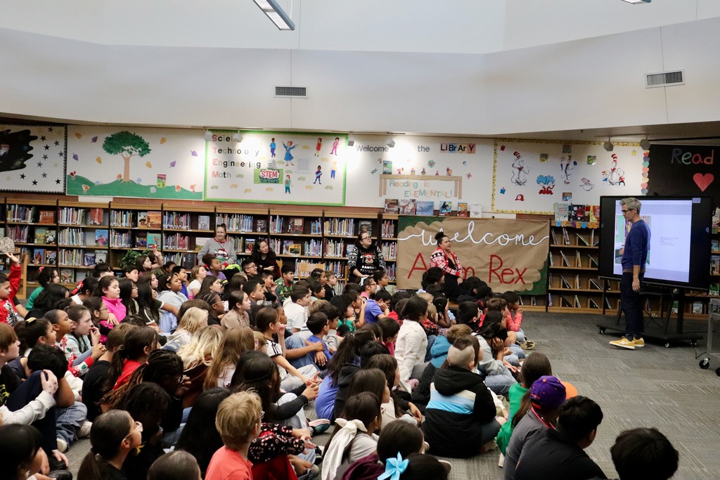 group of students listening to Adam Rex in the library