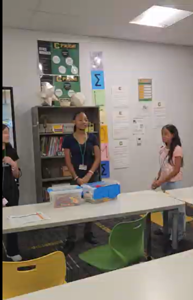Students passing a ball. 