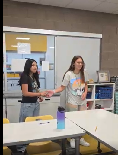 Students passing a ball. 