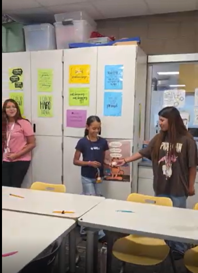 Students passing a ball. 