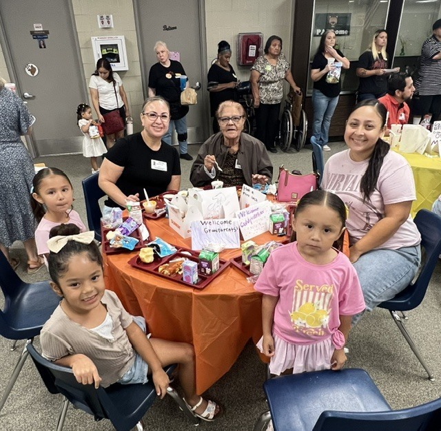Students eating lunch with their grandparents.