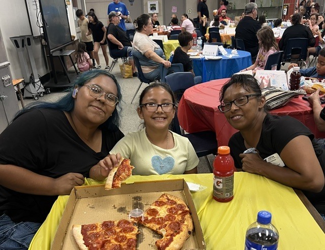 Student eating lunch with their grandparents.