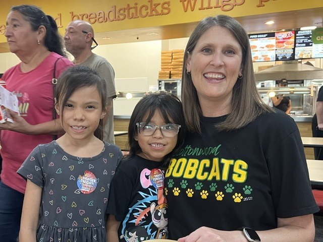 Cottonwood student at school fundraiser with the principal.
