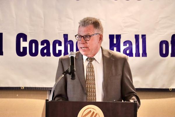 Mr. John Kashner speaking at a podium
