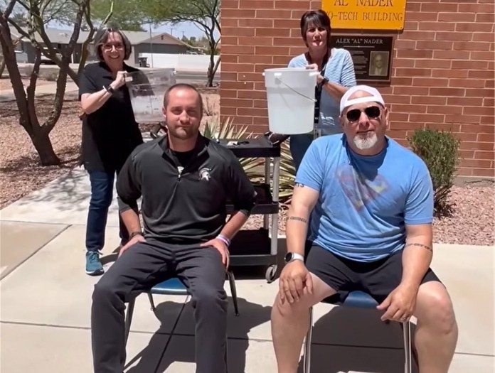 Vista Grande Principal Kevin Hubbard and CG Union Principal Dr. Chris Lineberry sitting in chairs awaiting the ice water to be poured on their heads