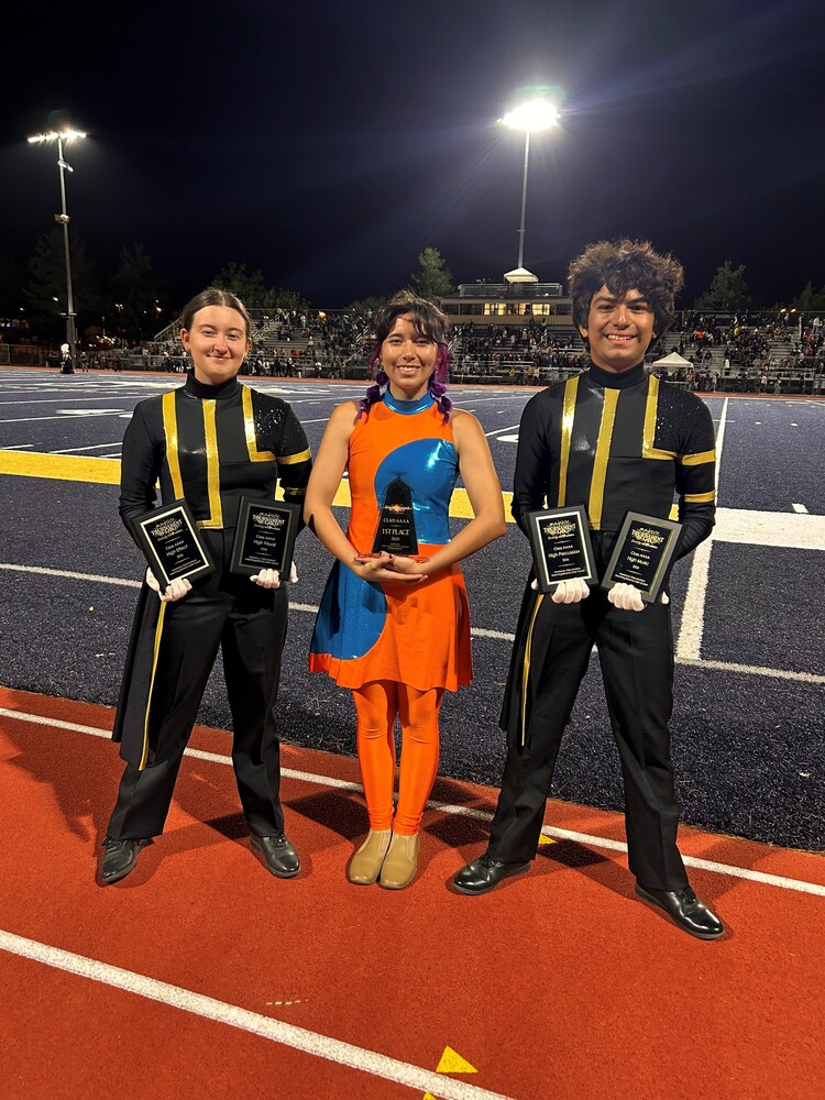 three band students posing with awards
