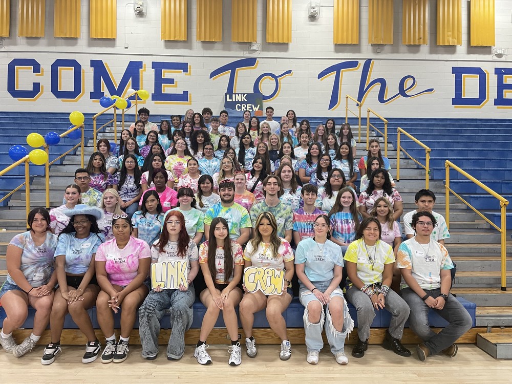 group of students sitting on bleechers posing for the camera @ Freshman First Day