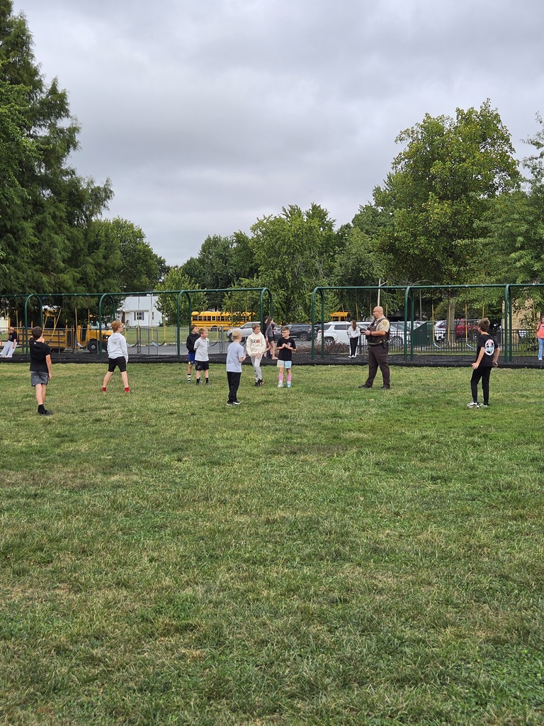 Deputy Hanley playing football with 5th grade students.