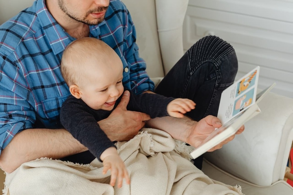 parent holding child reading