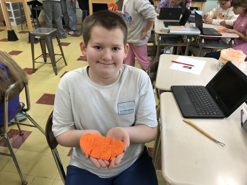 Sumerian Cuneiform - student holding clay name