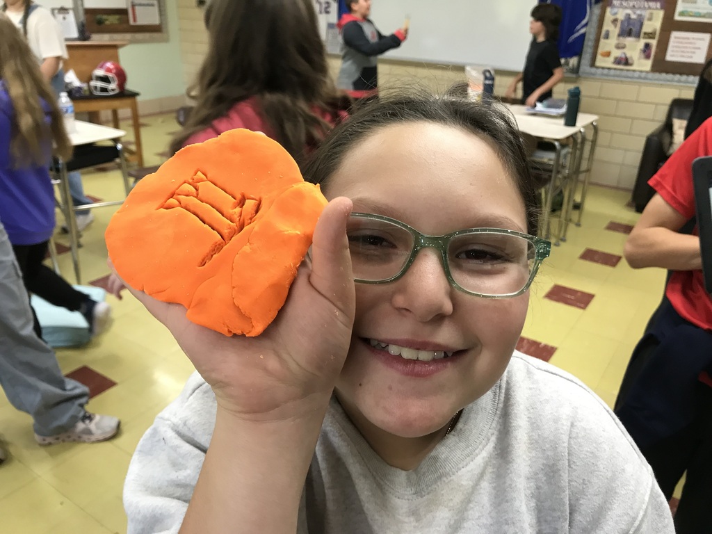 Sumerian Cuneiform - student holding clay name