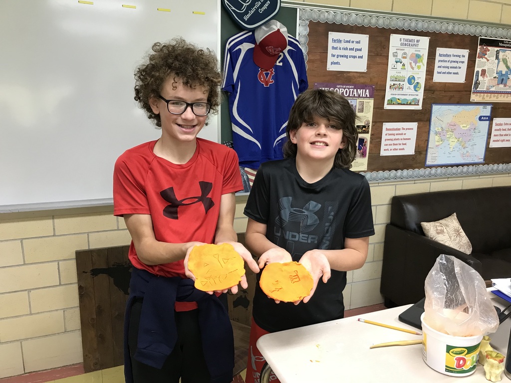 Sumerian Cuneiform - student holding clay name