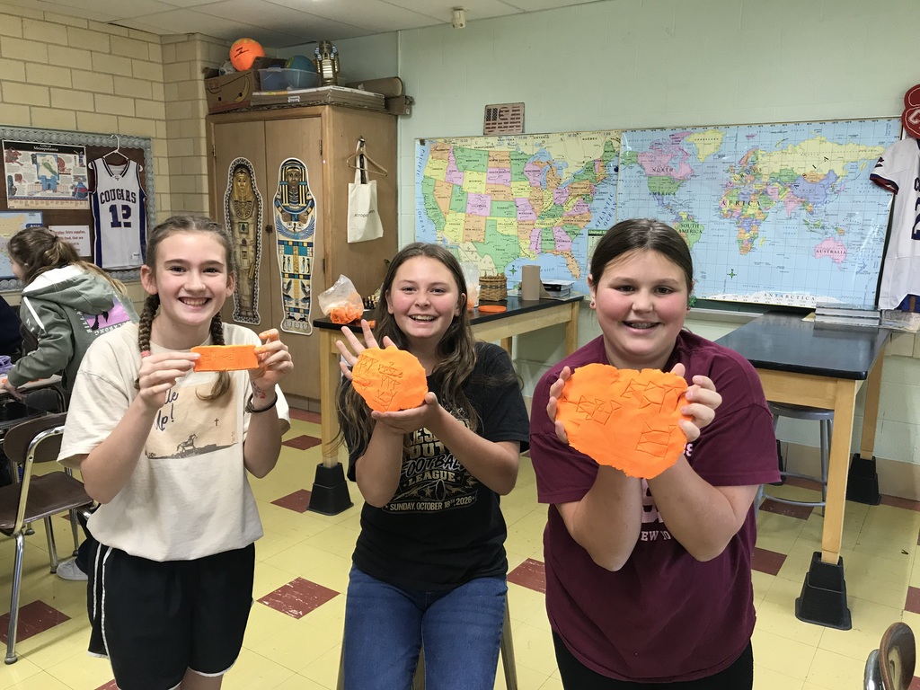 Sumerian Cuneiform - students holding clay names