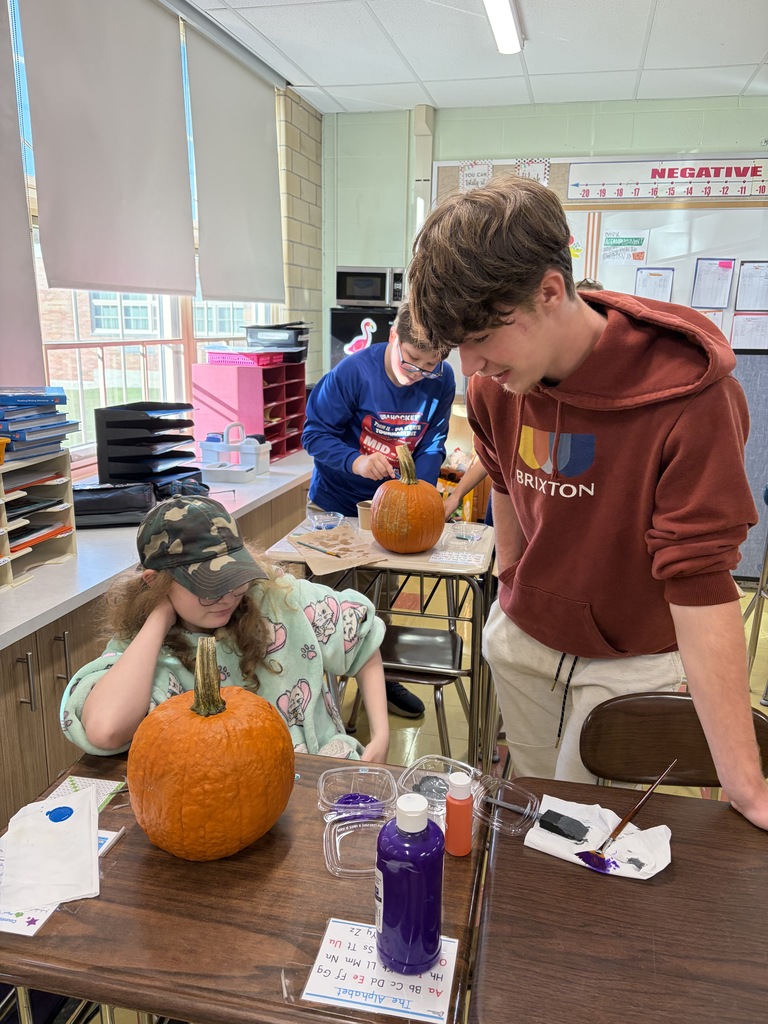 Key Club - students painting pumpkins in class