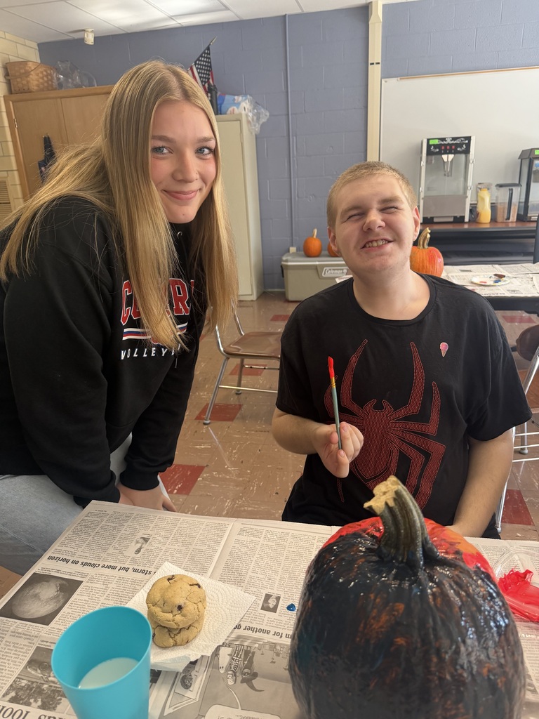 Key Club - students painting pumpkins in class
