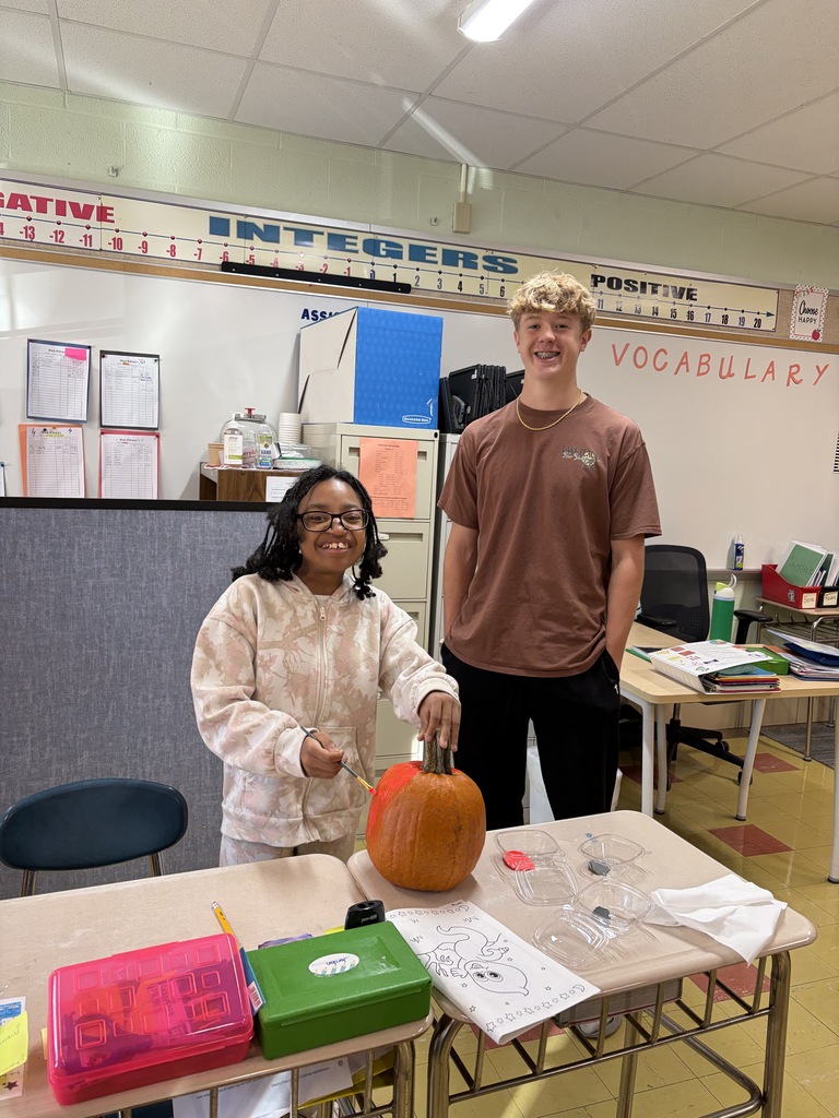 Key Club - students painting pumpkins in class
