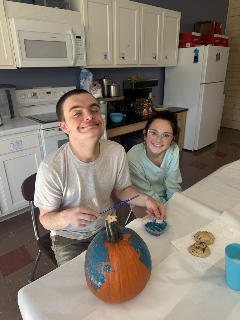 Key Club - students painting pumpkins in class