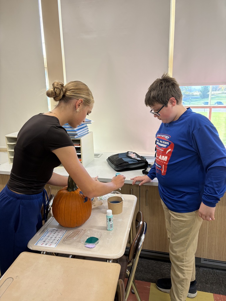 Key Club - students painting pumpkins in class
