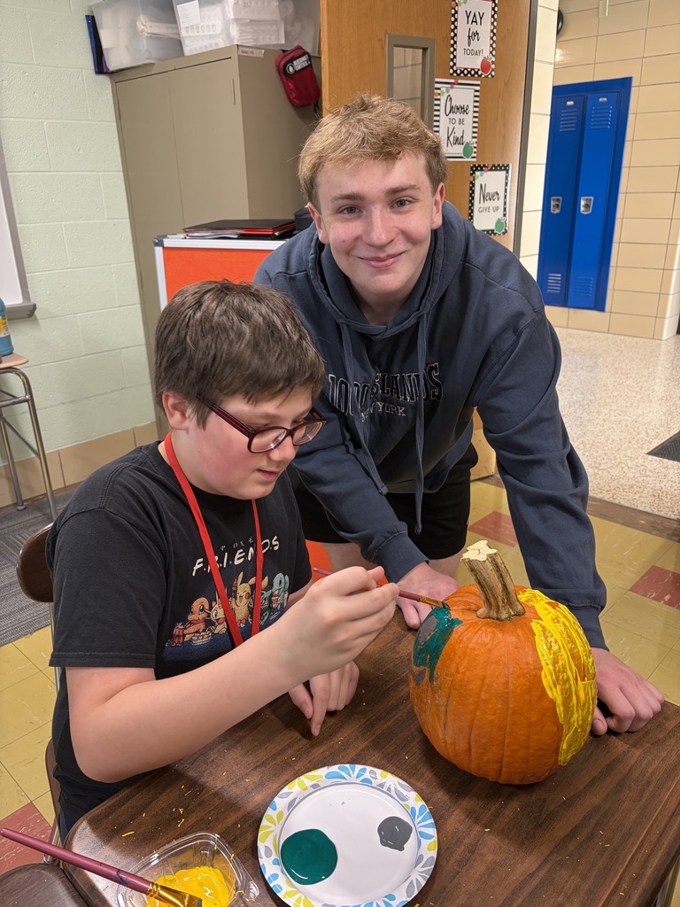 Key Club - students painting pumpkins in class