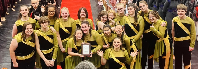 Catoosa winter guard team posing with plaque