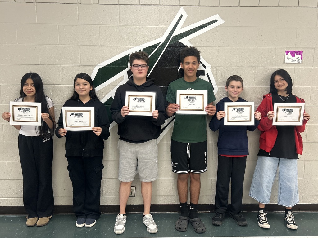 students pose with awards for April student of the month