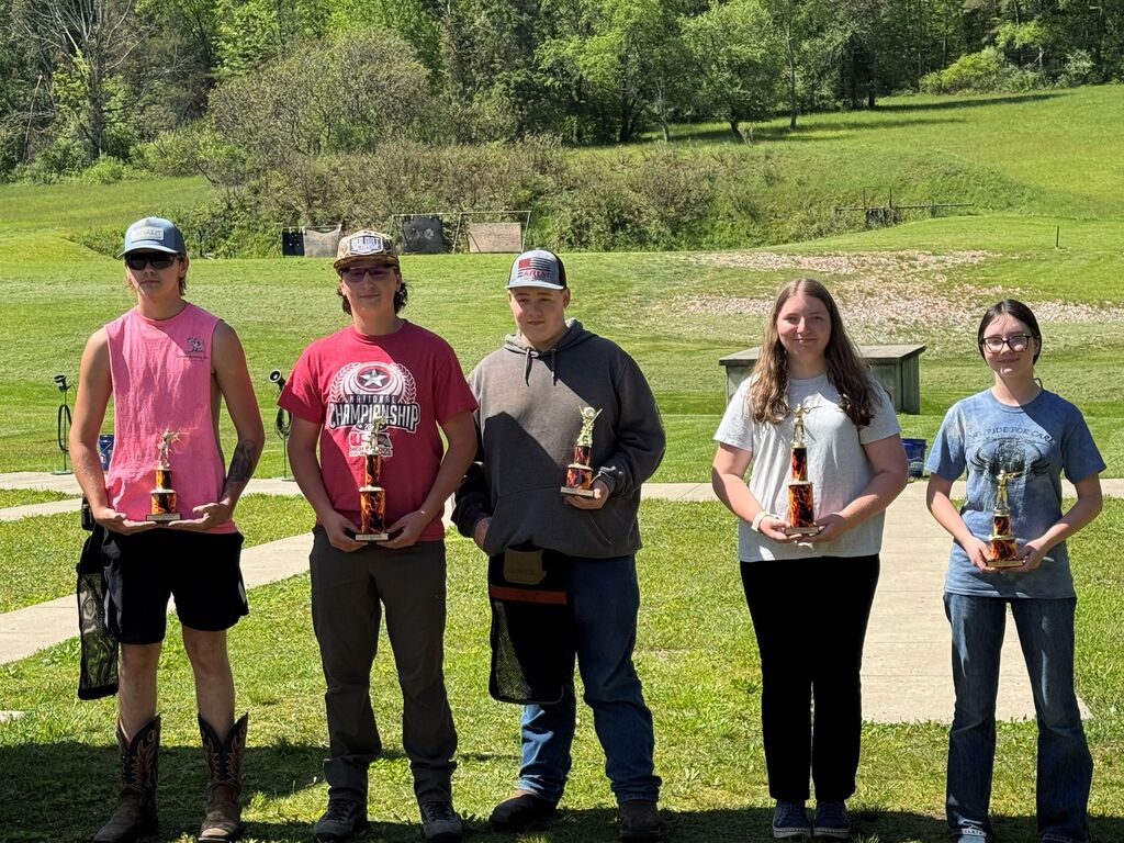 Five CLV Trap Club members holding trophies.