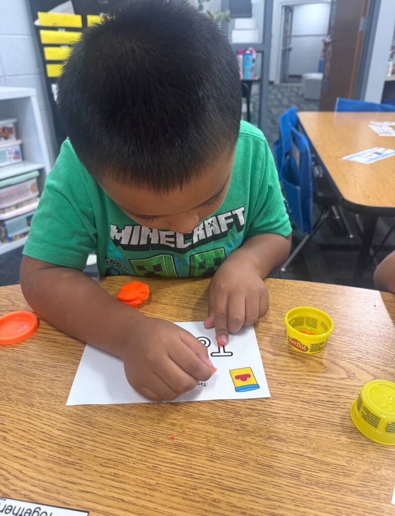 Student practicing writing name