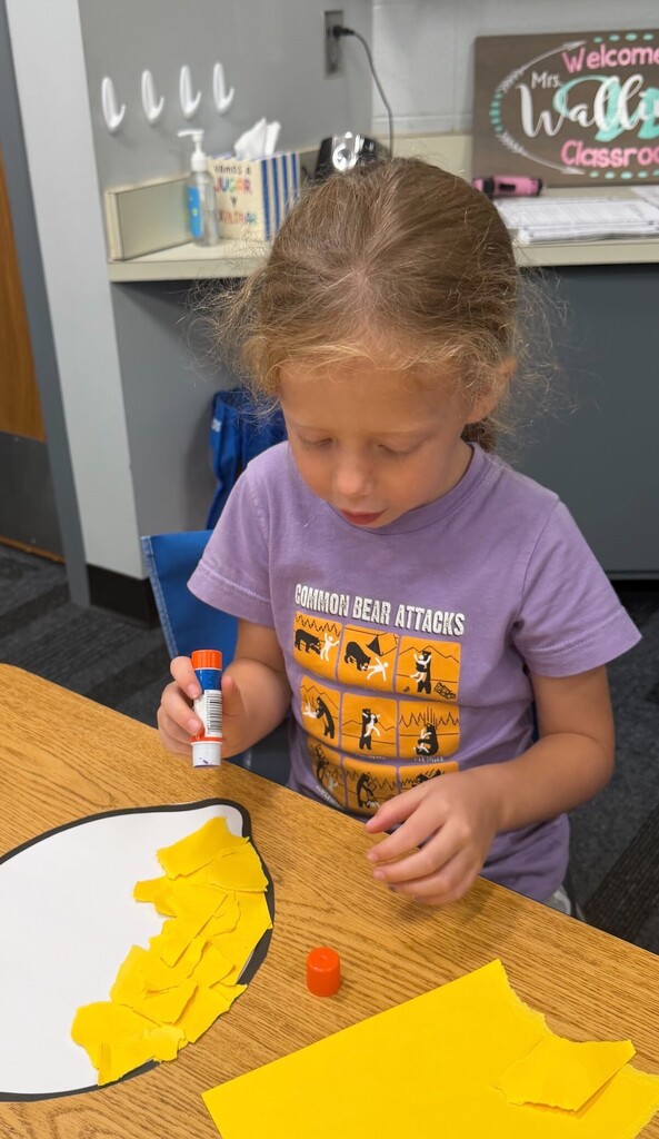 Student working on lemon-themed craft project