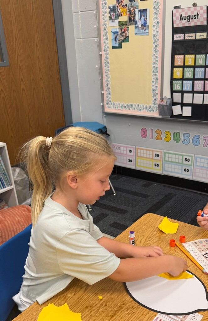 Student working on lemon-themed craft project