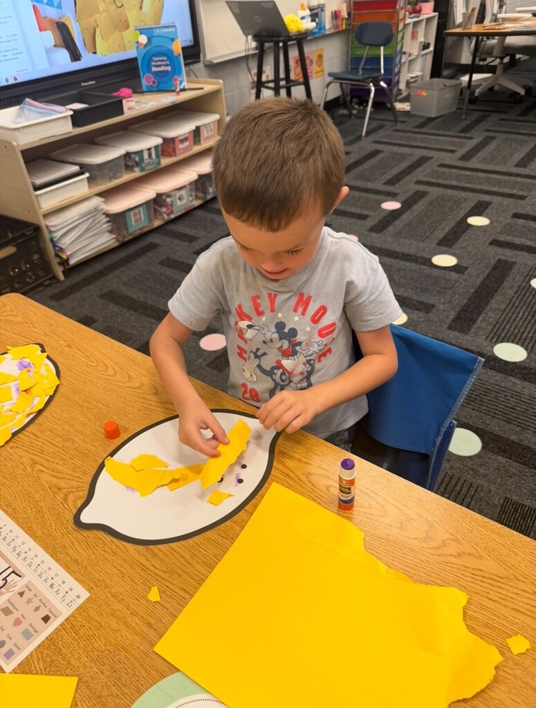 Student working on lemon-themed craft project
