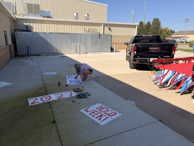 Senior student making signs for class float
