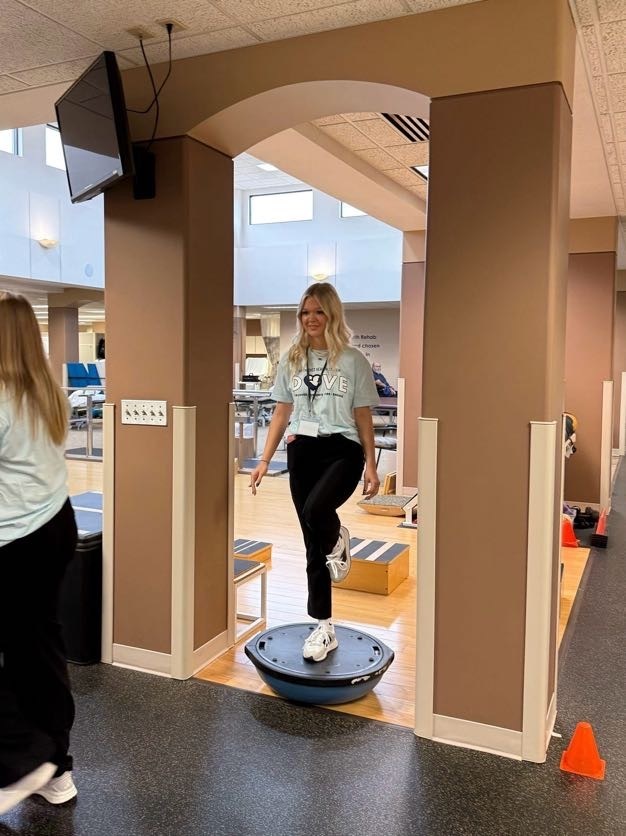 Student standing on one leg standing on balance disk