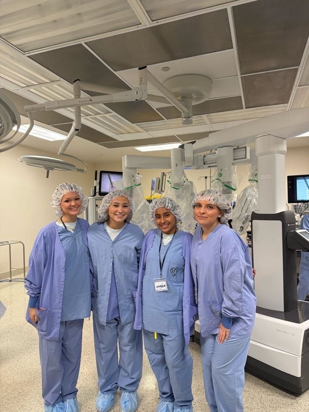 Three students and one staff member dressed in medical outfits