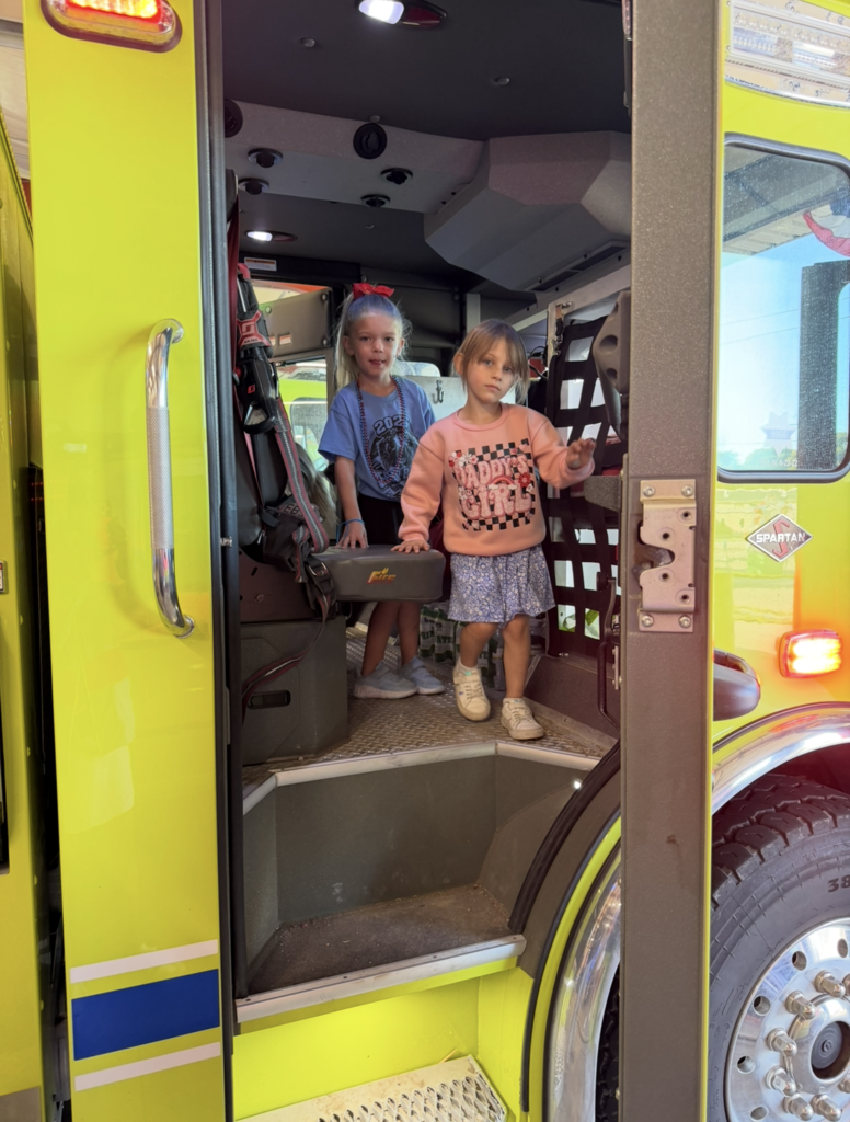 Two students inside of fire truck