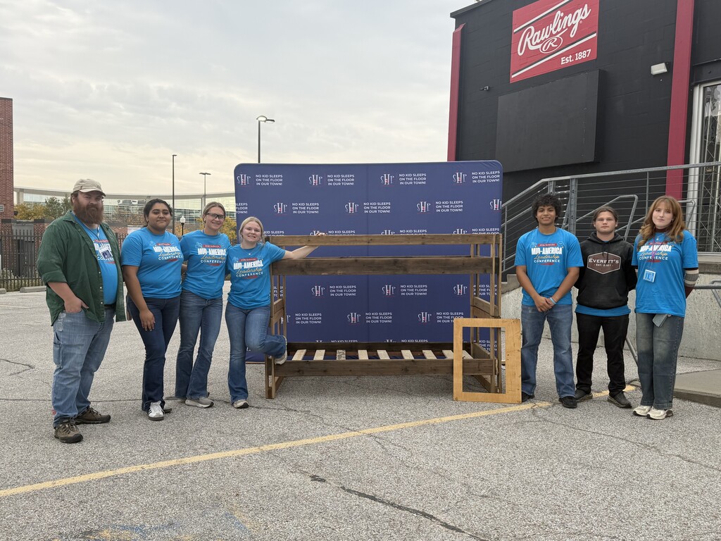 SkillsUSA students showcasing bunkbed that they built together