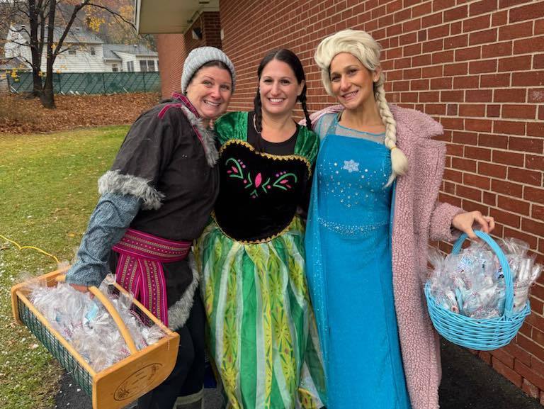 Teachers dressed as Elsa, Anna and Kristoff