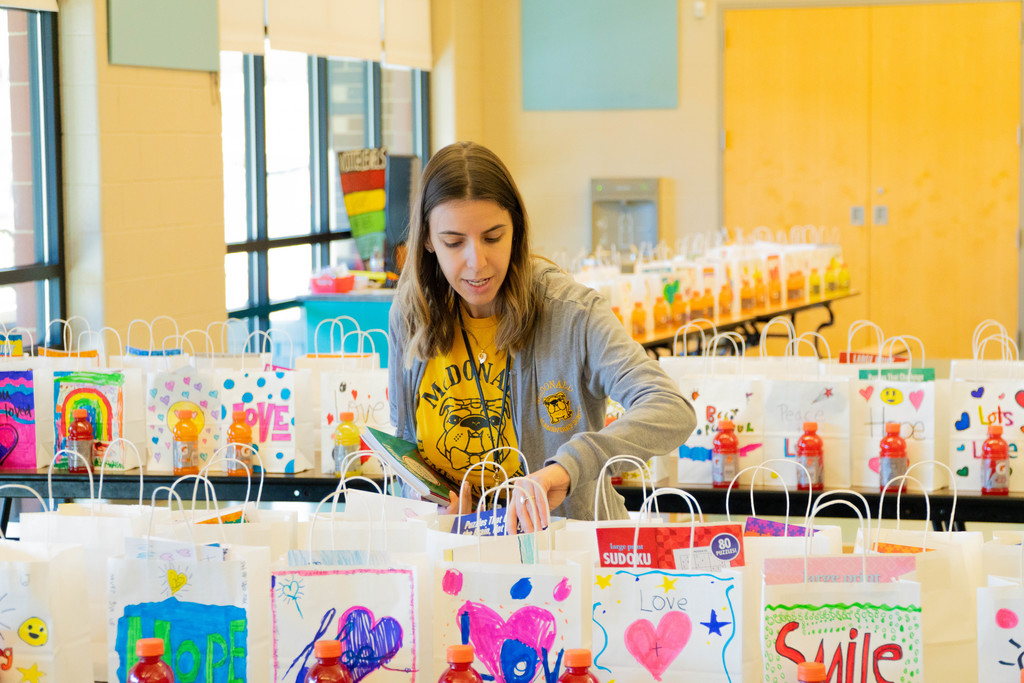 Photo of McDonald Elementary teacher getting goodie bags ready for St. Mary's Cancer Patients