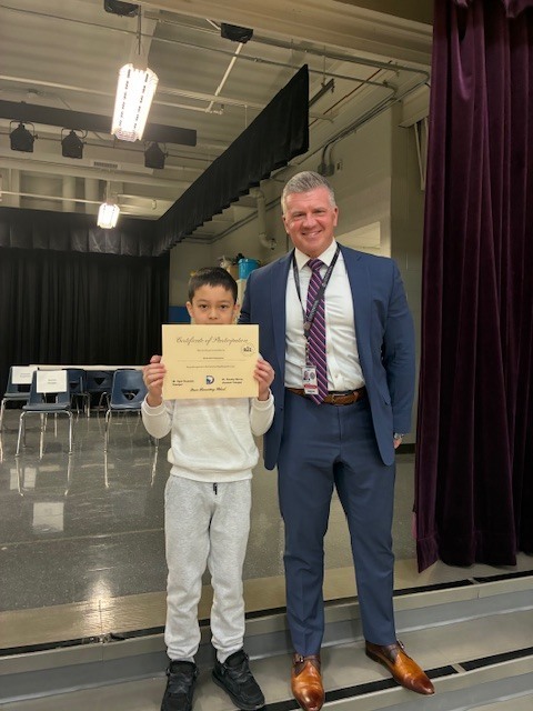 Photo of 5th grader Sardorbek Kupaysinov with CSD superintendent Dr. Lucabaugh