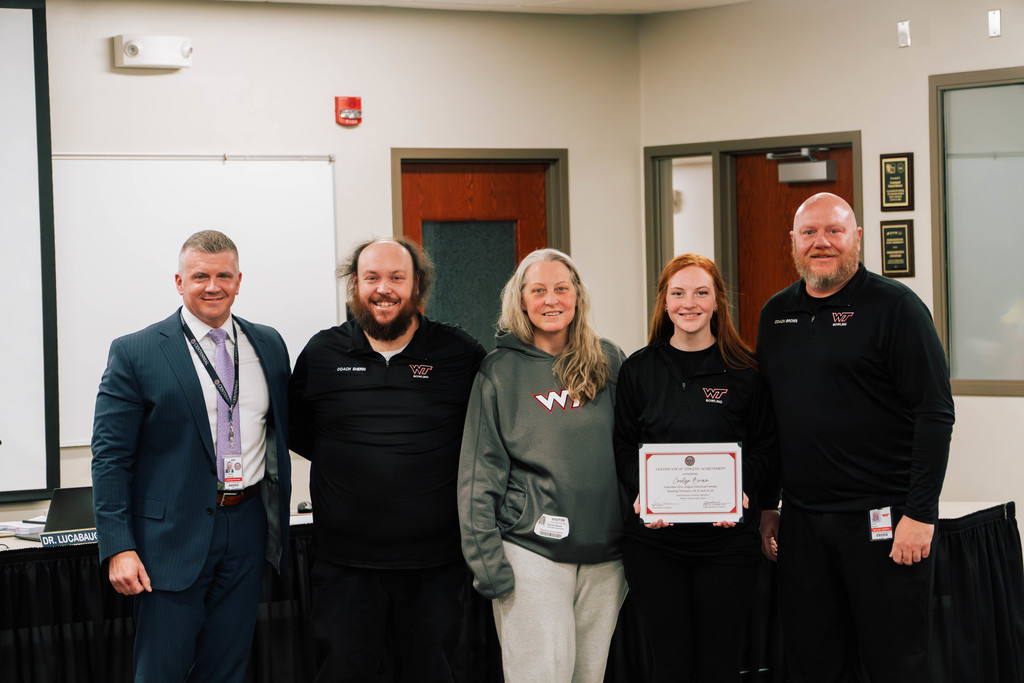 WTHS Senior Caelyn Brown with Superintendent Dr. Lucabugh, her parents, and coaches at a recent CSD board meeting